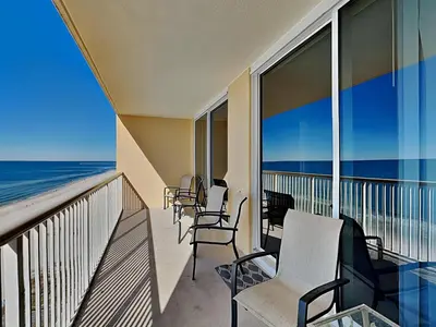 a balcony with chairs and a view of the ocean at Majestic Beach Towers II #1006 in Panama City Beach