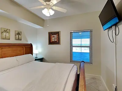 a bedroom with a bed and a flat screen tv at Majestic Beach Towers II #1006 in Panama City Beach