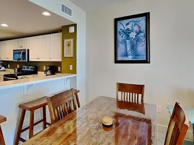a kitchen and dining room with a table and chairs at Majestic Beach Towers II #1006 in Panama City Beach