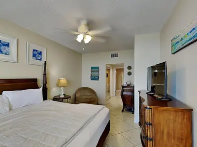 a bedroom with a bed and a flat screen tv at Majestic Beach Towers II #1006 in Panama City Beach