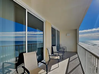 a balcony with chairs and a view of the ocean at Majestic Beach Towers II #1006 in Panama City Beach