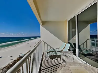 a balcony with a table and chairs on the beach at Majestic Beach Towers II #707 in Panama City Beach