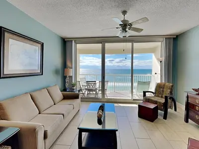 a living room with a couch and a view of the ocean at Majestic Beach Towers II #707 in Panama City Beach