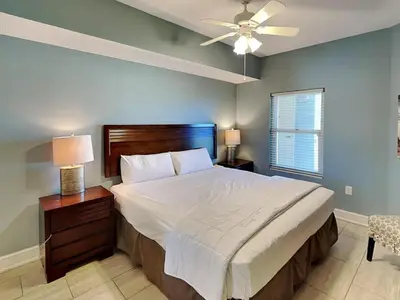 a bedroom with a large bed and a ceiling fan at Majestic Beach Towers II #707 in Panama City Beach