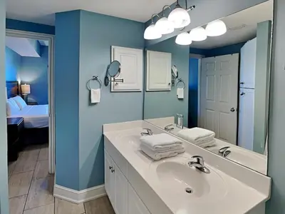 a bathroom with a sink and a large mirror at Majestic Beach Towers II #707 in Panama City Beach