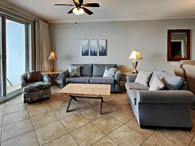 a living room with couches and a table at Twin Palms #1805A in Panama City Beach