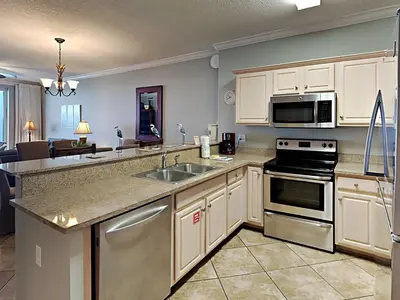 a kitchen with a sink and a stove top oven at Twin Palms #1805A in Panama City Beach
