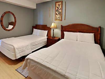 a bedroom with two white beds and a mirror at Twin Palms #1805A in Panama City Beach