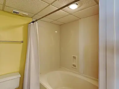 a bathroom with a shower and a tub and a toilet at Long Beach Resort Tower II #202 in Panama City Beach