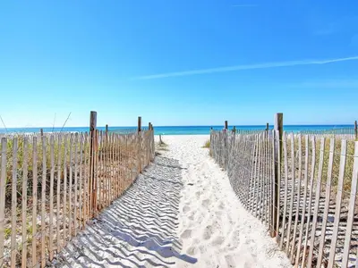 a fence on the beach next to the ocean at Long Beach Resort Tower II #202 in Panama City Beach