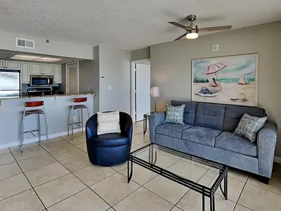 a living room with a couch and a kitchen at Long Beach Resort Tower II #305 in Panama City Beach