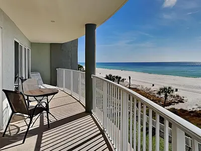 a balcony with a table and chair on the beach at Long Beach Resort Tower II #305 in Panama City Beach