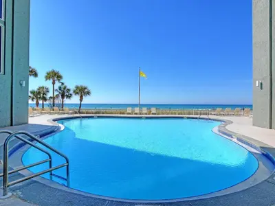 a large blue swimming pool with the beach in the background at Long Beach Resort Tower II #305 in Panama City Beach