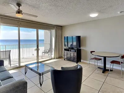 a living room with a couch and a tv and a table at Long Beach Resort Tower II #305 in Panama City Beach