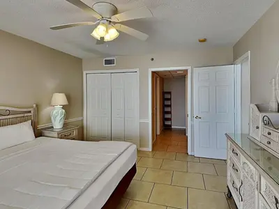 a bedroom with a bed and a ceiling fan at Long Beach Resort Tower III #402 in Panama City Beach