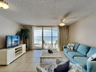 a living room with a blue couch and a tv at Long Beach Resort Tower III #402 in Panama City Beach