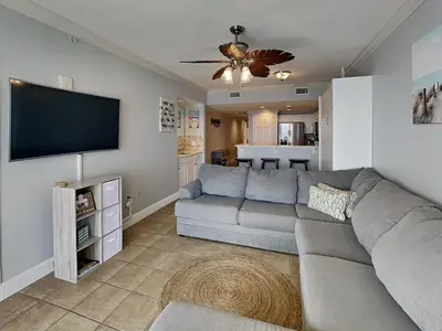 a living room with a couch and a flat screen tv at Majestic Beach Towers II #1902 in Panama City Beach