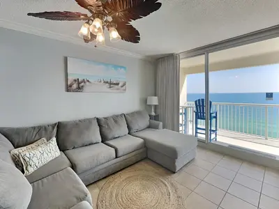 a living room with a couch and a view of the ocean at Majestic Beach Towers II #1902 in Panama City Beach