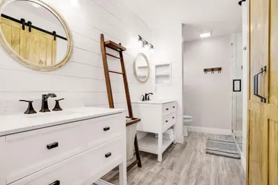 a white bathroom with a sink and a mirror at The Sand Castle in Panama City Beach