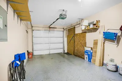 an empty garage with a white garage door at The Sand Castle in Panama City Beach