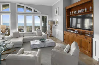 a living room with couches and a large television at Amazing Gulf Views 425A WaterSound Crossings 3BR Steps to Beach and Pool! condo in Panama City Beach