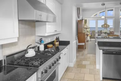 a kitchen with white cabinets and a stove top oven at Amazing Gulf Views 425A WaterSound Crossings 3BR Steps to Beach and Pool! condo in Panama City Beach