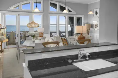 a kitchen and living room with a view of the ocean at Amazing Gulf Views 425A WaterSound Crossings 3BR Steps to Beach and Pool! condo in Panama City Beach