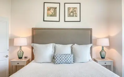 a bedroom with a large bed with two lamps at GULF FRONT PENTHOUSE CONDO COMPLIMENTARY GOLF CART 407 Compass Point 1, WaterSound - 3 BR, SLPS 8 condo in Panama City Beach