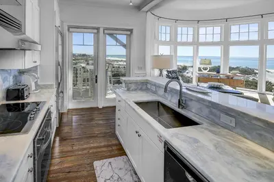 a kitchen with a sink and a large window at GULF FRONT PENTHOUSE CONDO COMPLIMENTARY GOLF CART 407 Compass Point 1, WaterSound - 3 BR, SLPS 8 condo in Panama City Beach