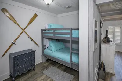 a bedroom with a bunk bed with blue pillows at Gulf Front Home in Seagrove Beach, FL with 3 Bedrooms and 3 Bathrooms home in Santa Rosa Beach
