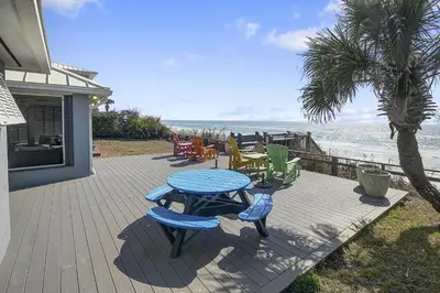 a patio with a table and chairs and the ocean at Gulf Front Home in Seagrove Beach, FL with 3 Bedrooms and 3 Bathrooms home in Santa Rosa Beach