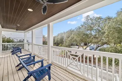 two blue chairs on a porch with a view at Private Pool and Short Walk to the Beach - Seagrove Beach FL home in Santa Rosa Beach
