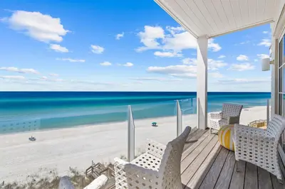 a porch with chairs and a view of the beach at Enchantment - Beach Front, Private Pool, Private Beach Access - 5BR 5BTH Home home in Panama City Beach