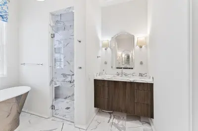 a white bathroom with a sink and a shower at Enchantment - Beach Front, Private Pool, Private Beach Access - 5BR 5BTH Home home in Panama City Beach