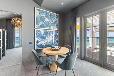 a dining room with a table and chairs at Enchantment - Beach Front, Private Pool, Private Beach Access - 5BR 5BTH Home home in Panama City Beach