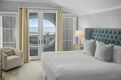 a bedroom with a bed and a chair and a window at AMAZING GULF VIEWS 420B WaterSound Crossings 3BR, Corner Unit condo in Panama City Beach