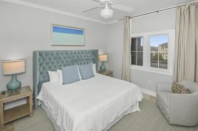 a bedroom with a bed and a chair and a window at AMAZING GULF VIEWS 420B WaterSound Crossings 3BR, Corner Unit condo in Panama City Beach