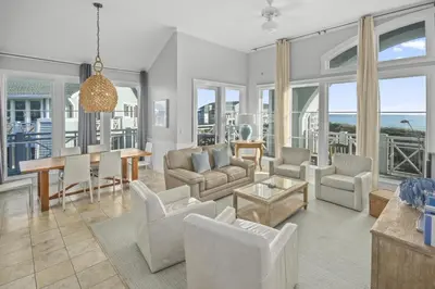 a living room with white furniture and a table at AMAZING GULF VIEWS 420B WaterSound Crossings 3BR, Corner Unit condo in Panama City Beach