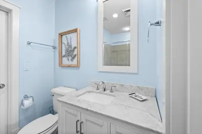 a white bathroom with a sink and a toilet at GULF VIEWS from ALL Bedrooms! 308 Compass Point 1 in WaterSound - Short walk to the beach and pool condo in Panama City Beach