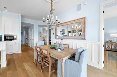 a kitchen and dining room with a wooden table and chairs at GULF VIEWS from ALL Bedrooms! 308 Compass Point 1 in WaterSound - Short walk to the beach and pool condo in Panama City Beach