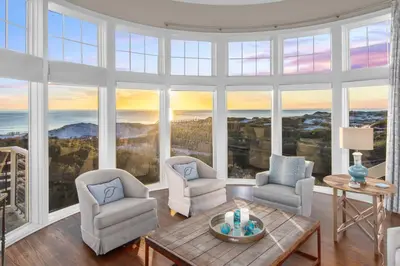 a living room with two chairs and a table at NEW RENTAL Beach Front Condo in WaterSound Beach FL with Stunning Views! condo in Panama City Beach