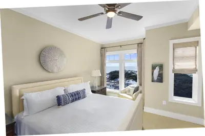 a bedroom with a bed and a ceiling fan at NEW RENTAL Beach Front Condo in WaterSound Beach FL with Stunning Views! condo in Panama City Beach