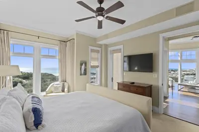 a bedroom with a bed and a flat screen tv at NEW RENTAL Beach Front Condo in WaterSound Beach FL with Stunning Views! condo in Panama City Beach