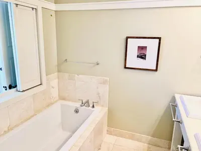 a white bathroom with a tub and a window at NEW RENTAL Beach Front Condo in WaterSound Beach FL with Stunning Views! condo in Panama City Beach