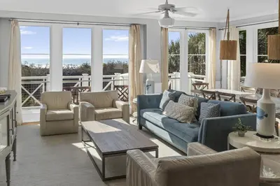 a living room with a blue couch and chairs at Spacious, Gulf Views 110B WaterSound Crossings Steps to Beach and Pool condo in Panama City Beach