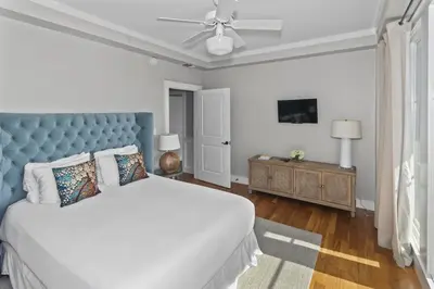 a bedroom with a large bed with a blue headboard at Spacious, Gulf Views 110B WaterSound Crossings Steps to Beach and Pool condo in Panama City Beach