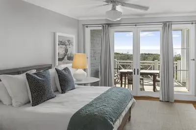 a bedroom with a bed with a view of a balcony at Spacious, Gulf Views 110B WaterSound Crossings Steps to Beach and Pool condo in Panama City Beach