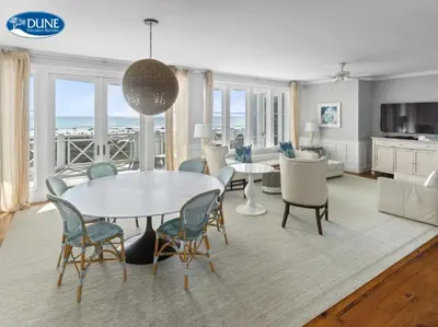 a dining room and living room with a table and chairs at BEAUTIFUL GULF VIEWS Spacious, Updated 316B WaterSound Crossings Steps to Beach and Pool condo in Panama City Beach