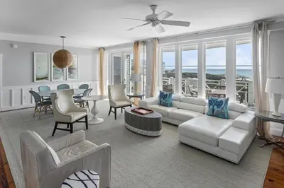 a living room with a couch and a table and chairs at BEAUTIFUL GULF VIEWS Spacious, Updated 316B WaterSound Crossings Steps to Beach and Pool condo in Panama City Beach