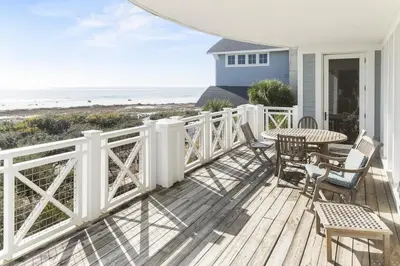 a porch with a table and chairs and the beach at BEAUTIFUL GULF VIEWS Spacious, Updated 316B WaterSound Crossings Steps to Beach and Pool condo in Panama City Beach